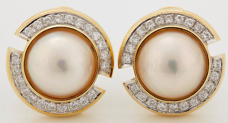 A pair of 18K gold and mabe pearl earrings set with round brilliant-cut diamonds.