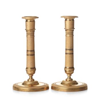 74. A pair of French Empire candlesticks, early 19th century.