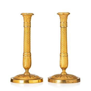 A pair of French Empire ormolu candlesticks, Paris, early 19th century.