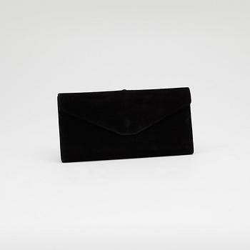 GUCCI, a black suede wallet with red leather lining.