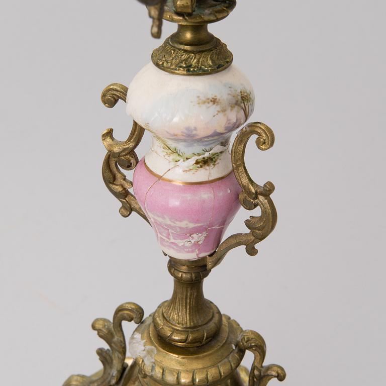 A pair of gilt-bronze Rococo Revival candelabra with porcelain decors, from the latter half of the 19th century.