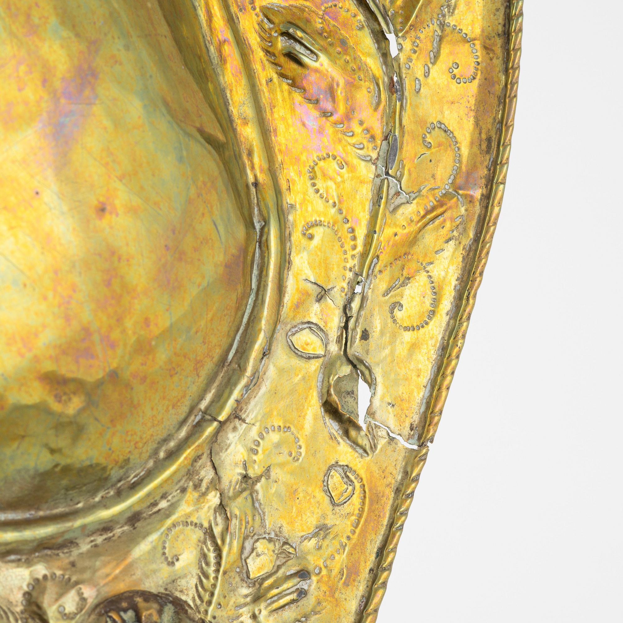 A pair of Baroque repoussé brass one-light sconces, first part of the 18th Century.