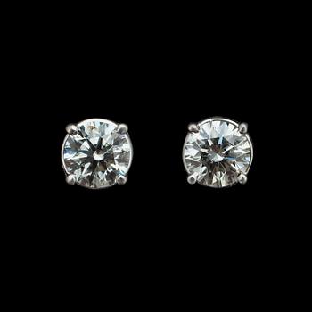 1057. A pair of brilliant cut diamond ear studs.