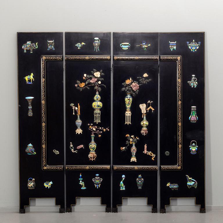 A Chinese lacquered and enameled folding screen.