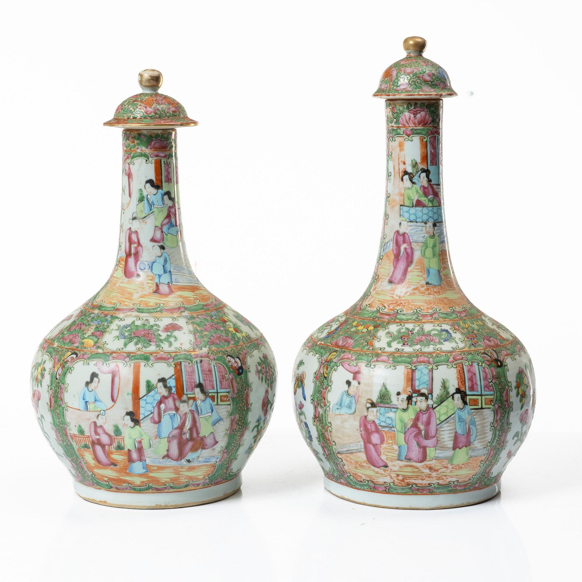 Two famille rose 'Canton' vases with covers, Qing dynasty, 19th century.