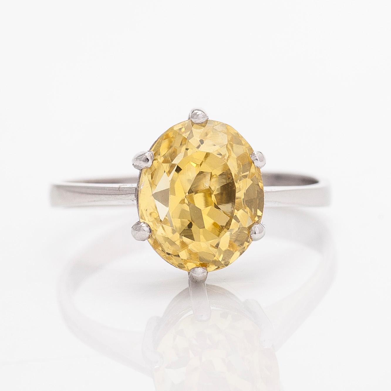 An 18K white gold ring with an oval faceted sapphire.