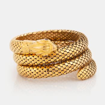 387. An 18K gold snake bracelet set with rubies.