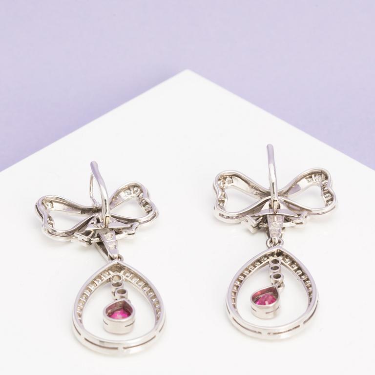 A pair of ruby and single-cut diamond earrings in the shape of bows. .