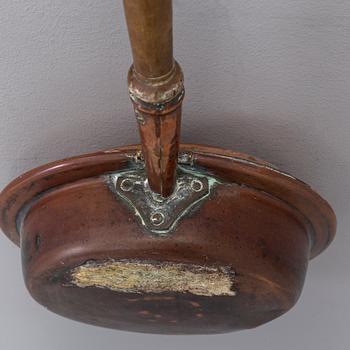 A 18th century copper bed warmer.