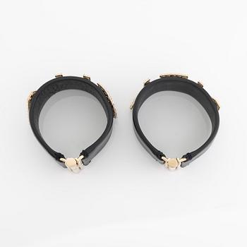 Chanel, a pair of black leather and rhinestone bracelets.