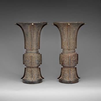 1303. A pair of large archaistic shaped bronze Gu vases, Ming dynasty (1368-1644).