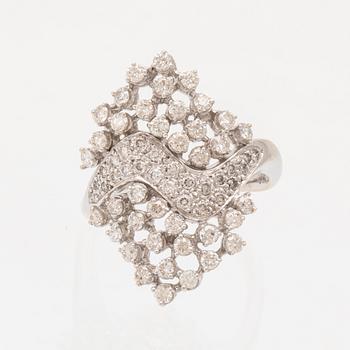 An 18K white gold ring set with round brilliant cut diamonds.