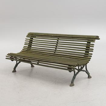 A cast iron-frame garden sofa, circa 1900.