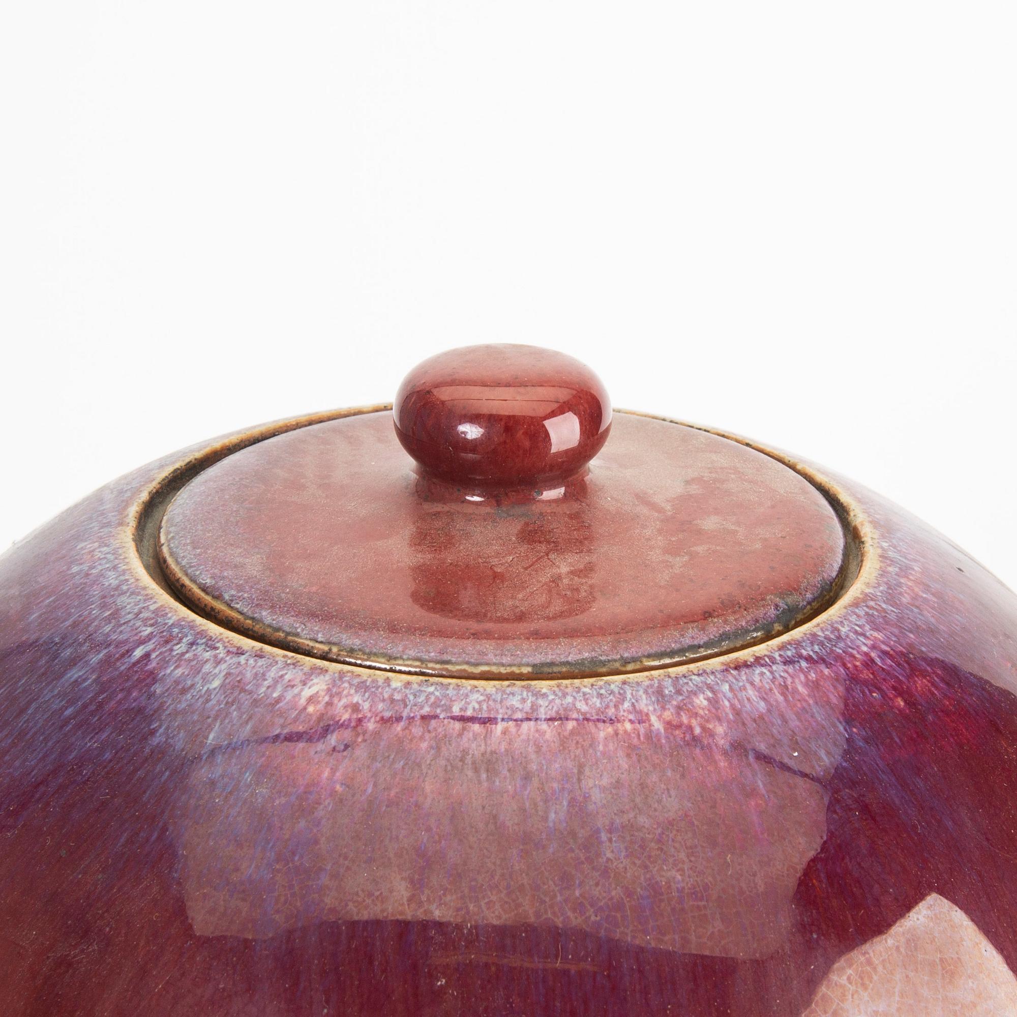 A sang de boef/flambe glazed jar with cover, Qing dynasty, circa 1900.