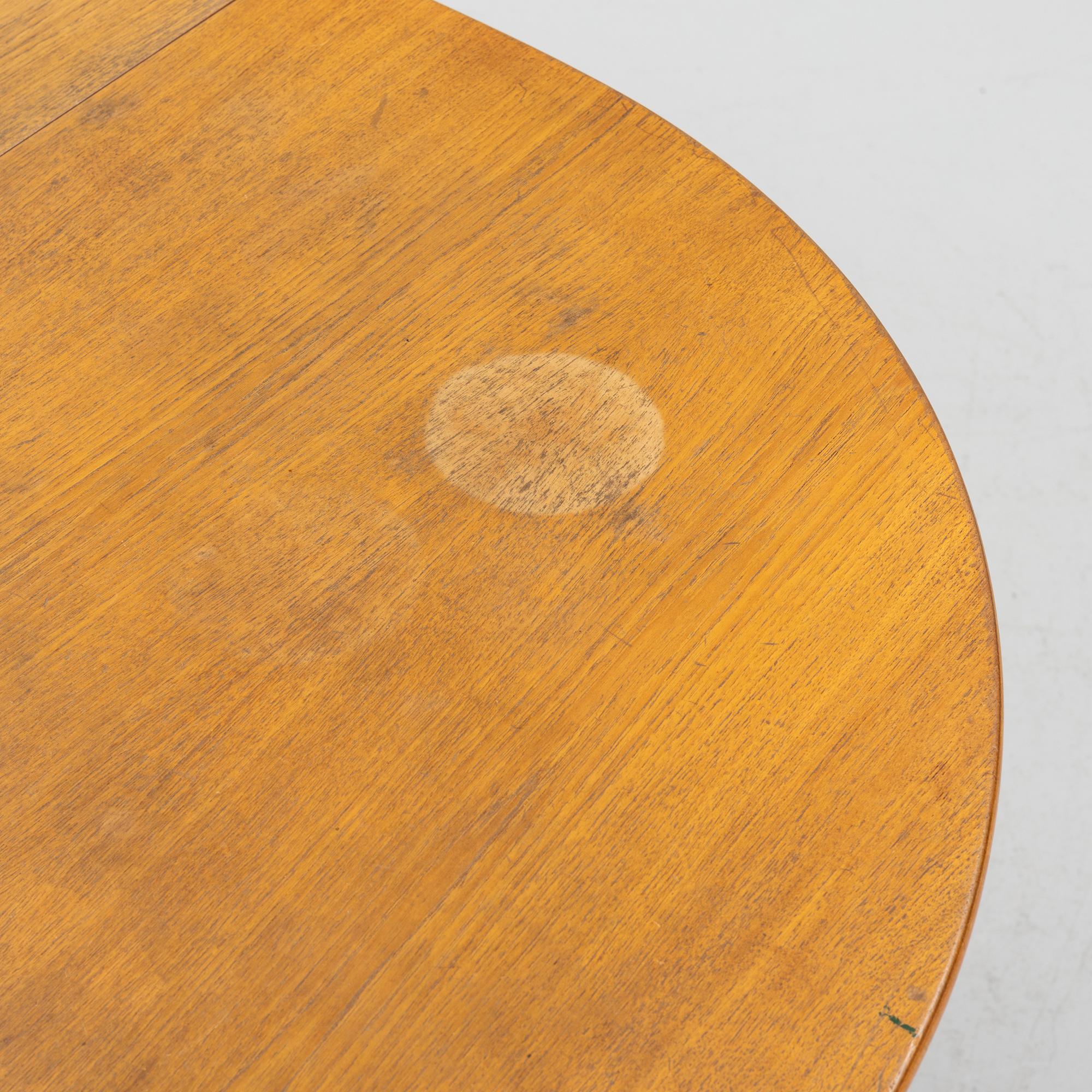 A gate-leg table, mid 20th Century.