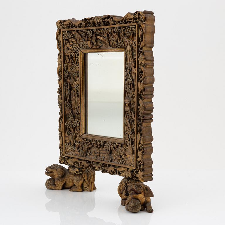 A Chinese wood mirror, 20th century.