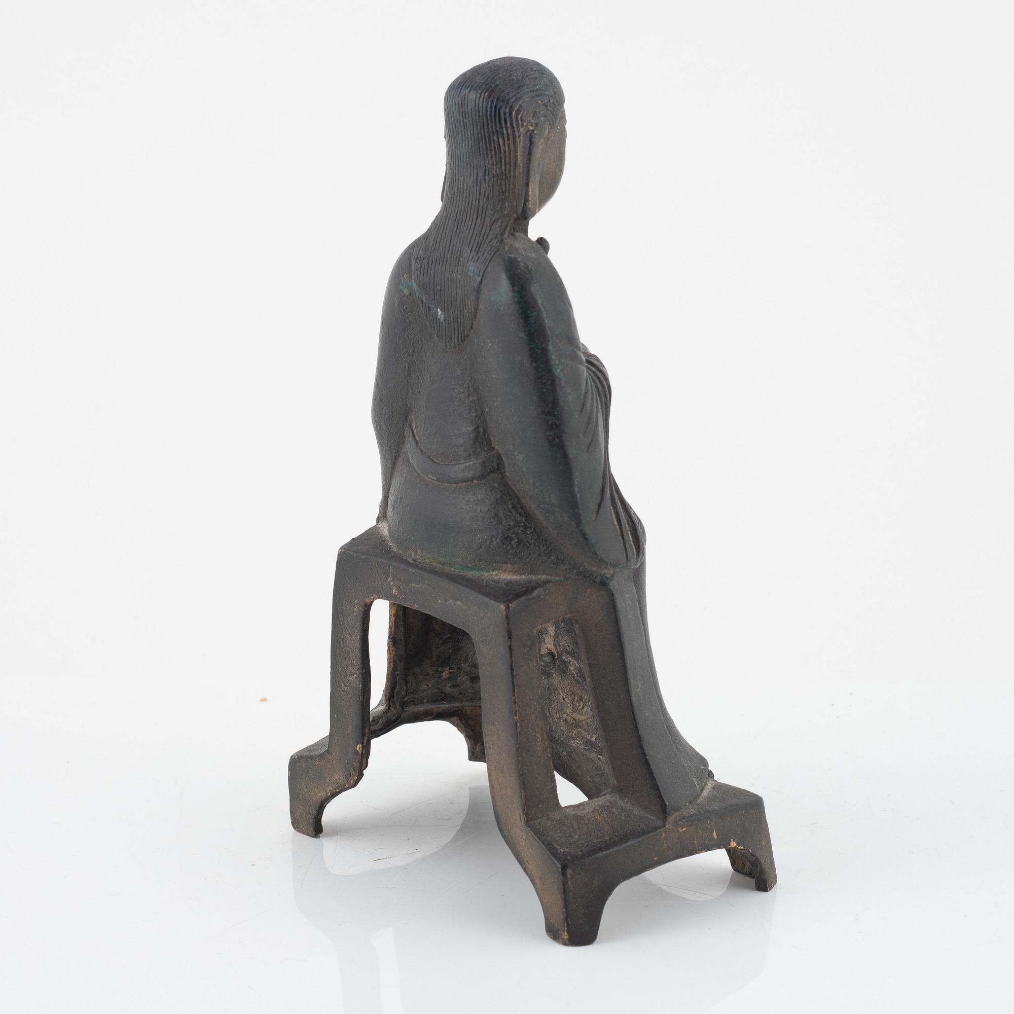 A bronze sculpture of a seated deity, Ming style, probably 20th Century.
