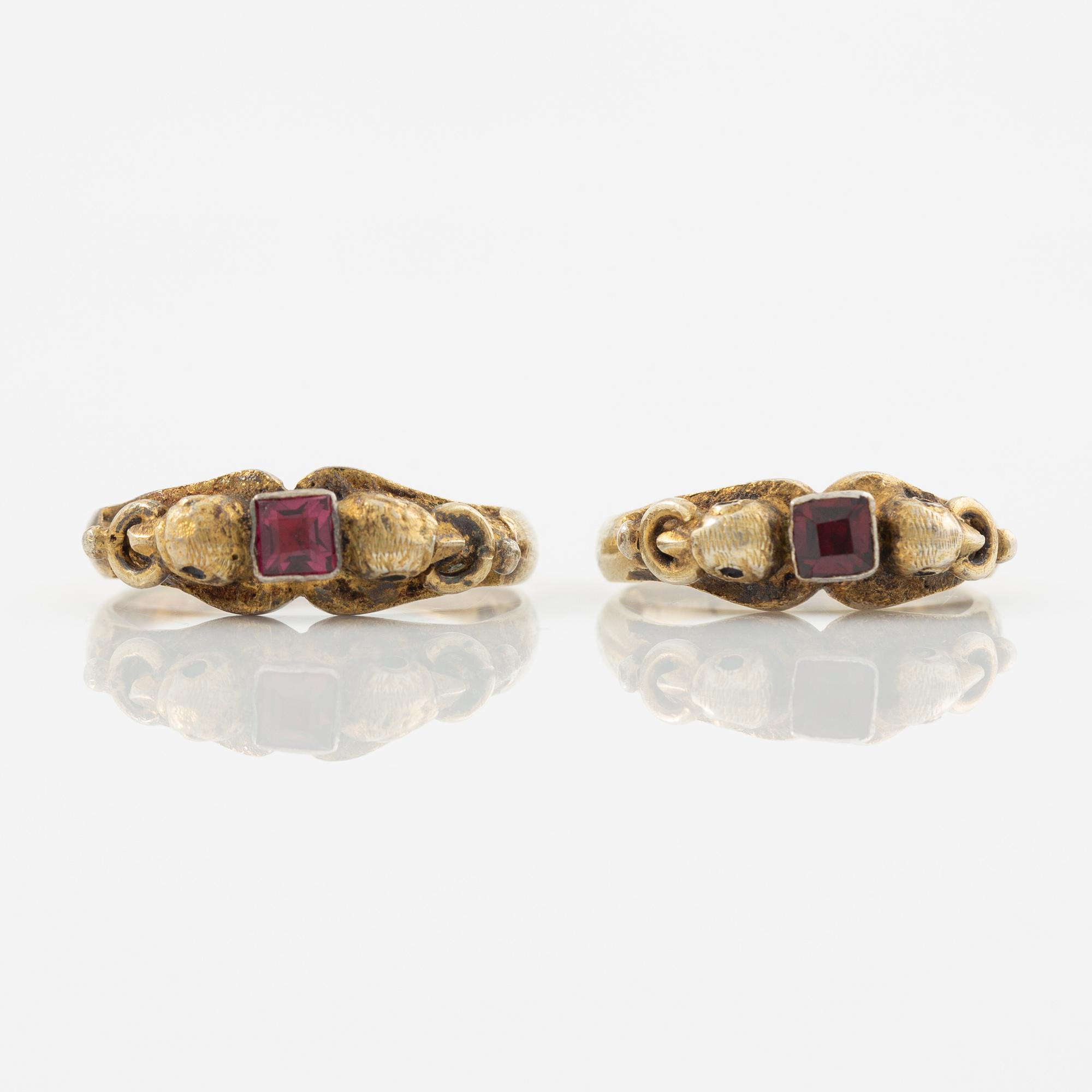 Two rings in silver with pink/red stones.