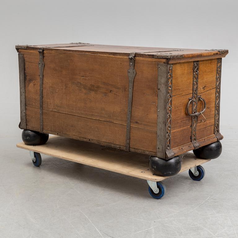 A 18th century baroque oak chest with iron mountings.