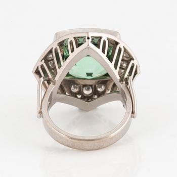 An 18K white gold ring set with a faceted tourmaline and round brilliant- and eight-cut diamonds.