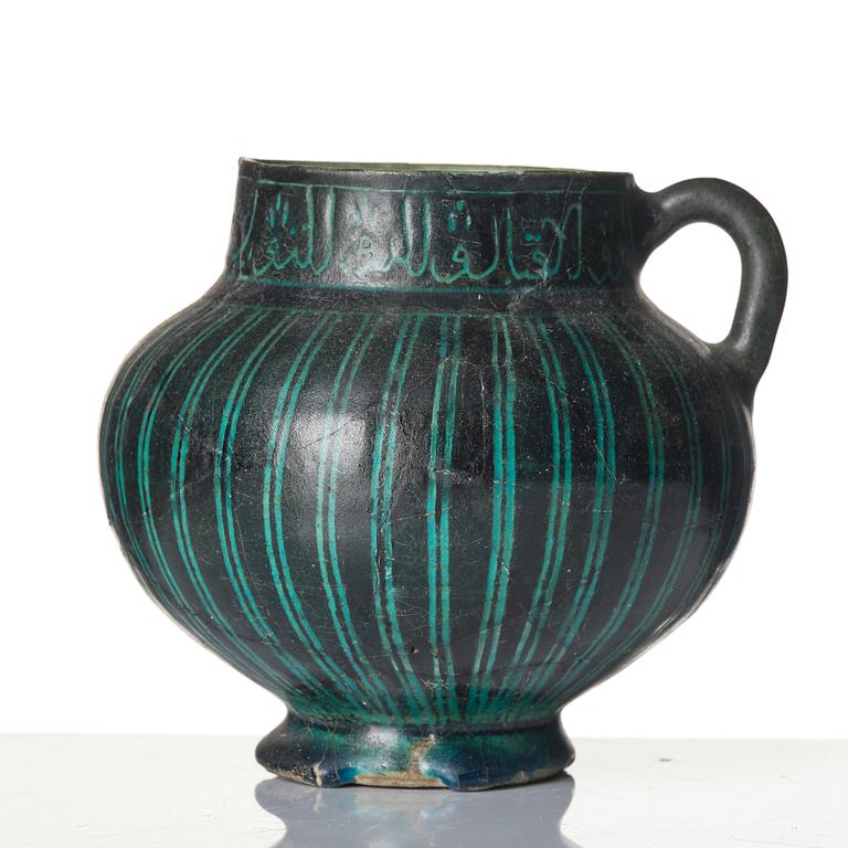 A Kashan Silhouette ware turquoise glazed pottery jug, central Iran, circa 1200.