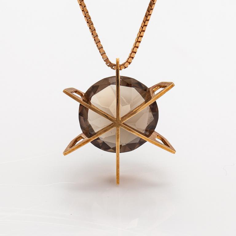 A 14K gold necklace with a smoky quartz. Martti Tapio Aarnio, Helsinki 1966.