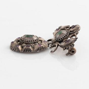Silver brooch with emeralds and rubies.