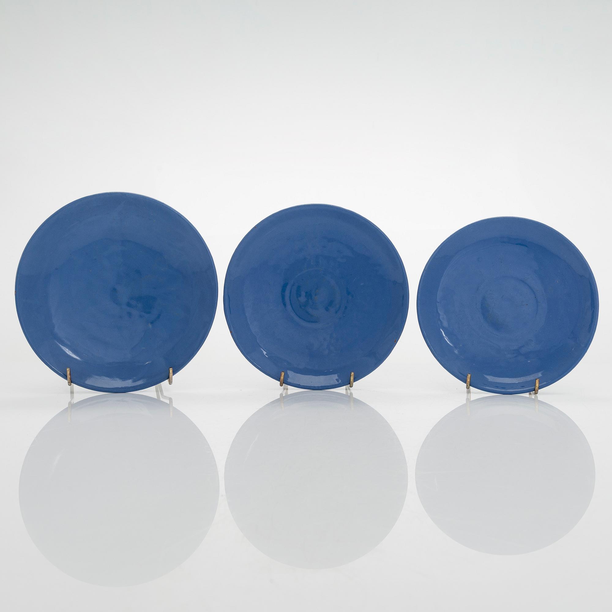 Marita Lybeck, a set of three ceramic plates and cream jug, red clay, signed ML.