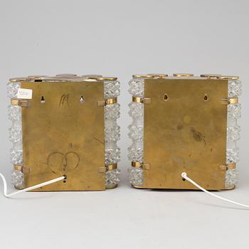 A pair of 1970's glass and brass wall lamps.