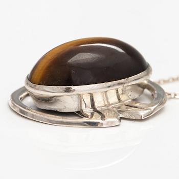 A silver ring and necklace with tiger's eye. Kultasepät Salovaara, Turku 1961.
