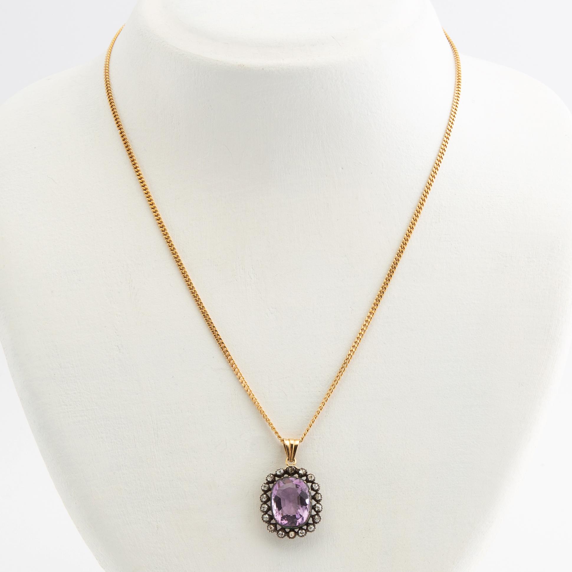 Pendant, 18k gold with diamonds and purple stone.