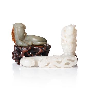 A sculptured nephrite belt buckle, figurine and brush washer, late Qing dynasty.