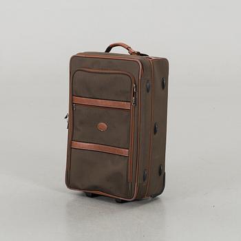 A LONGCHAMP SUITCASE.