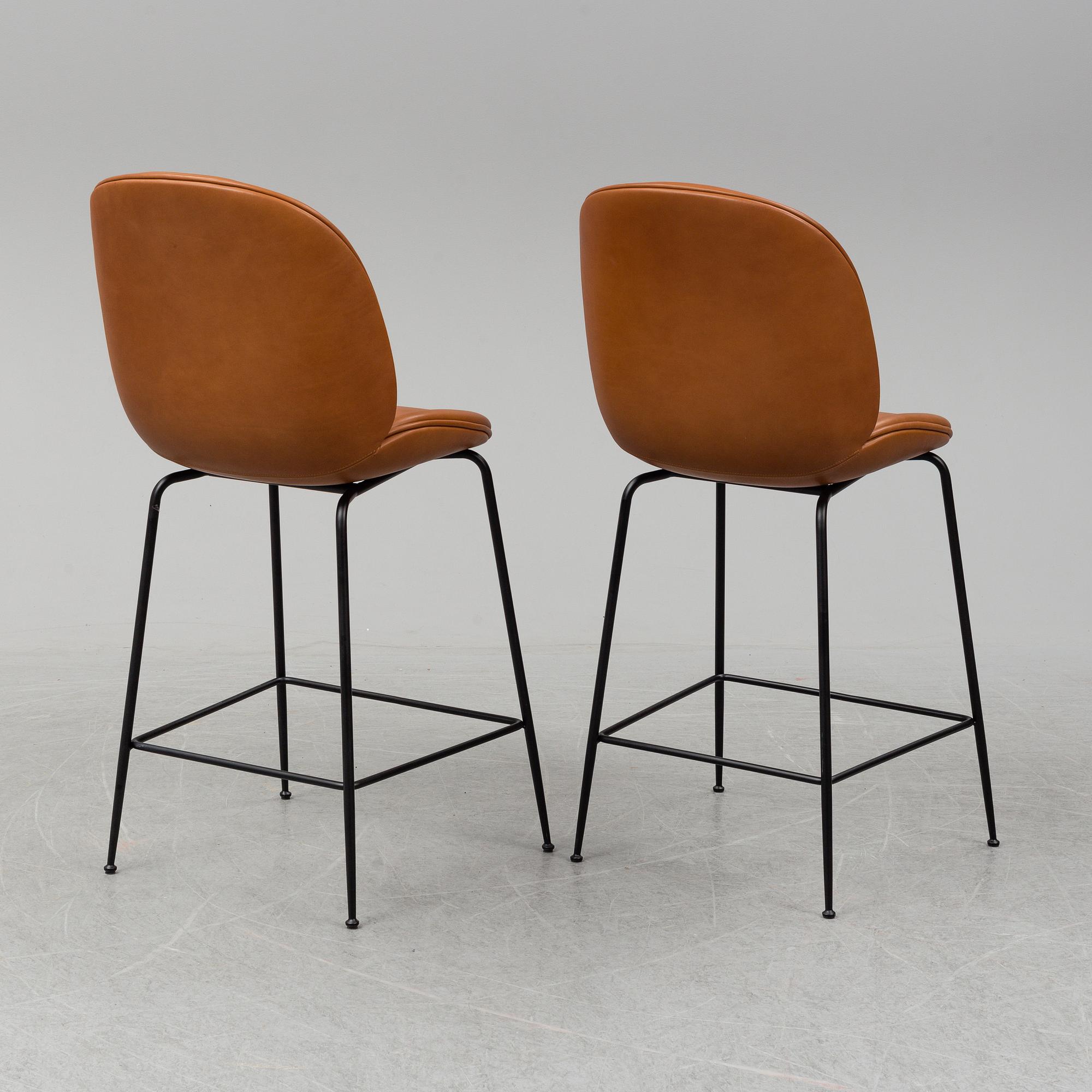 GAMFRATESI, a pair of 'Beetle Bar' leather chairs from GUBI.