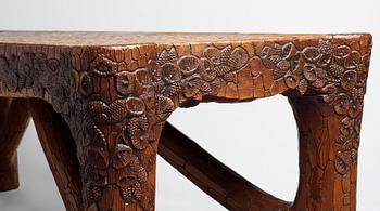 Gustaf Fjaestad, an Art Nouveau carved pine table, Arvika Sweden 1914, a double to the table in the Thiel Collection,