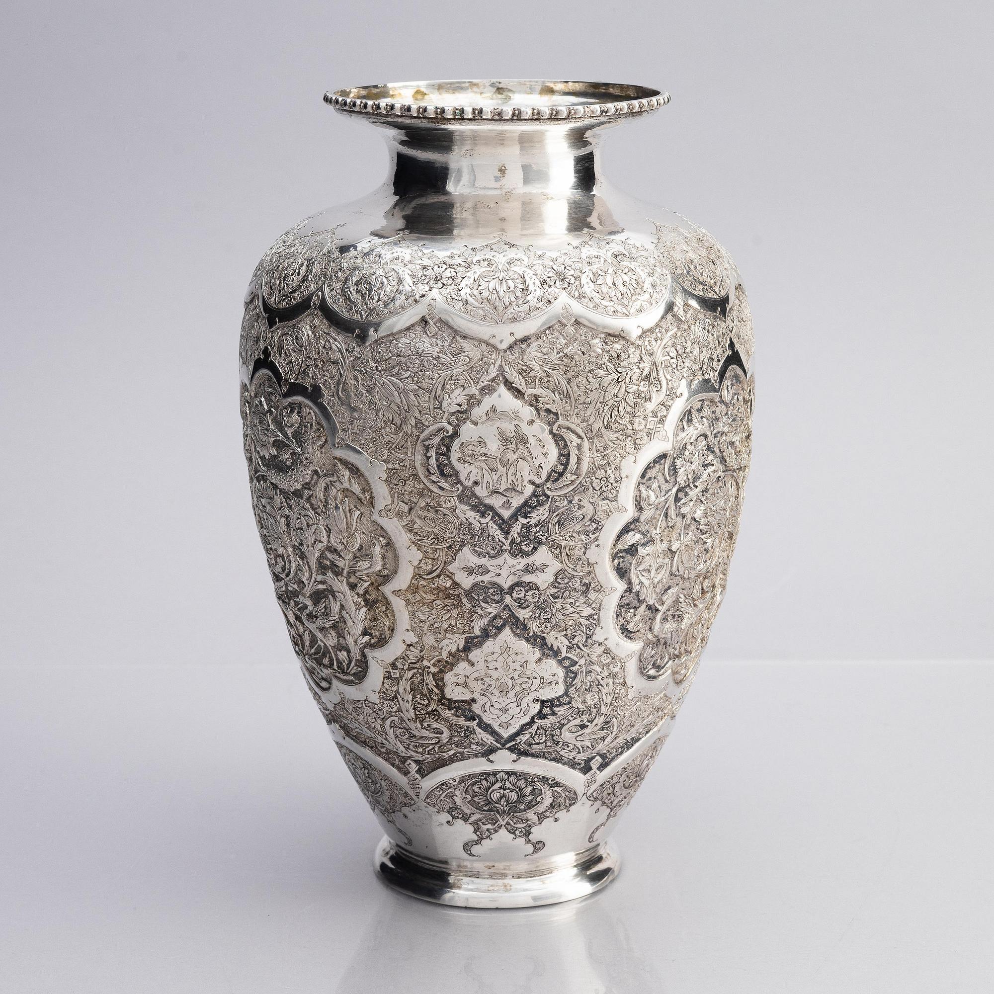 A Persian silver vase, late Qajar dynasty around 1910.