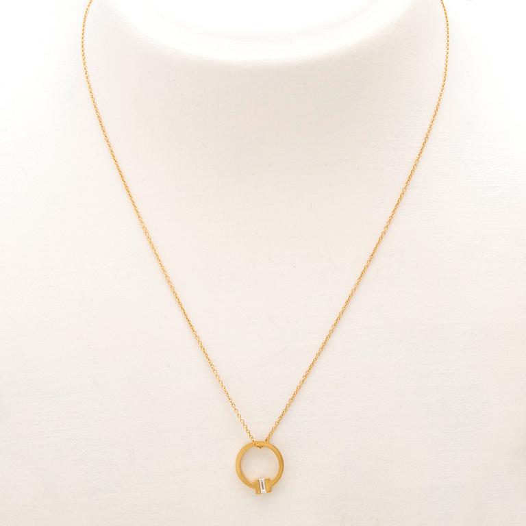 Tiffany & Co, "T" necklace in 18K gold with a baguette-cut diamond.