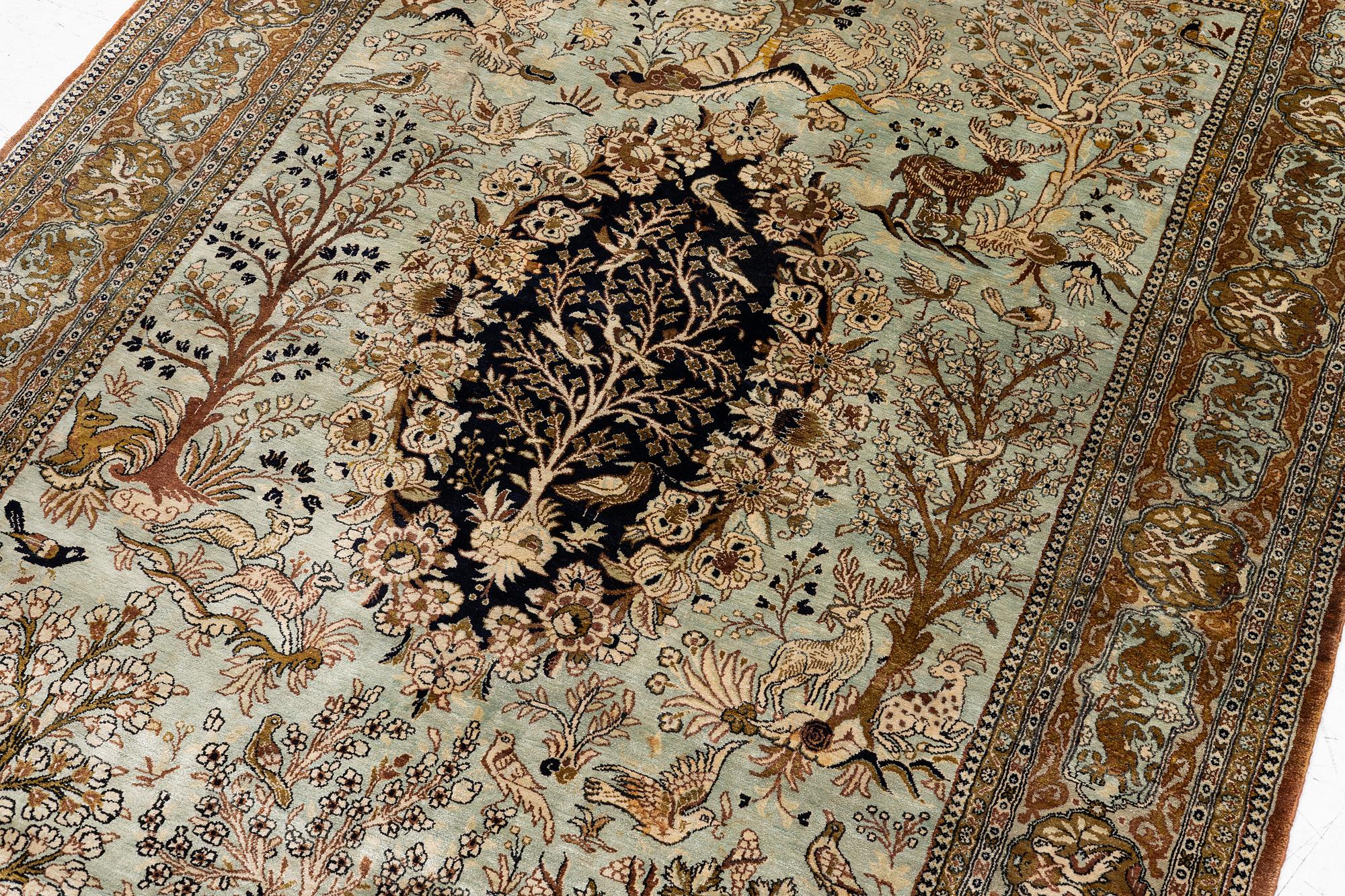 A Ghom, figural, silk rug, c. 205 x 140 cm.