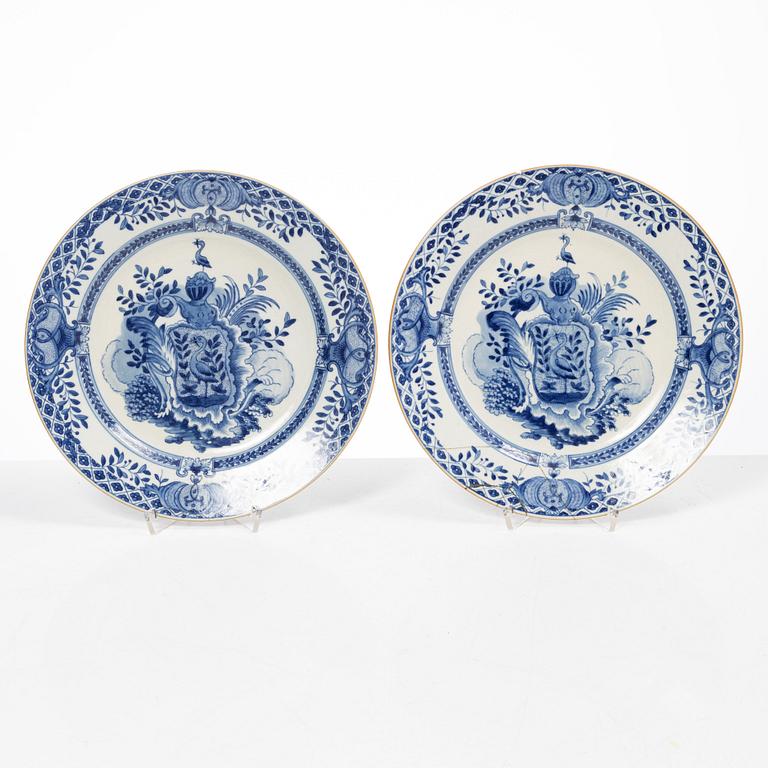 A pair of armorial dinner plates, soft paste, Qing dynasty, 18th century.