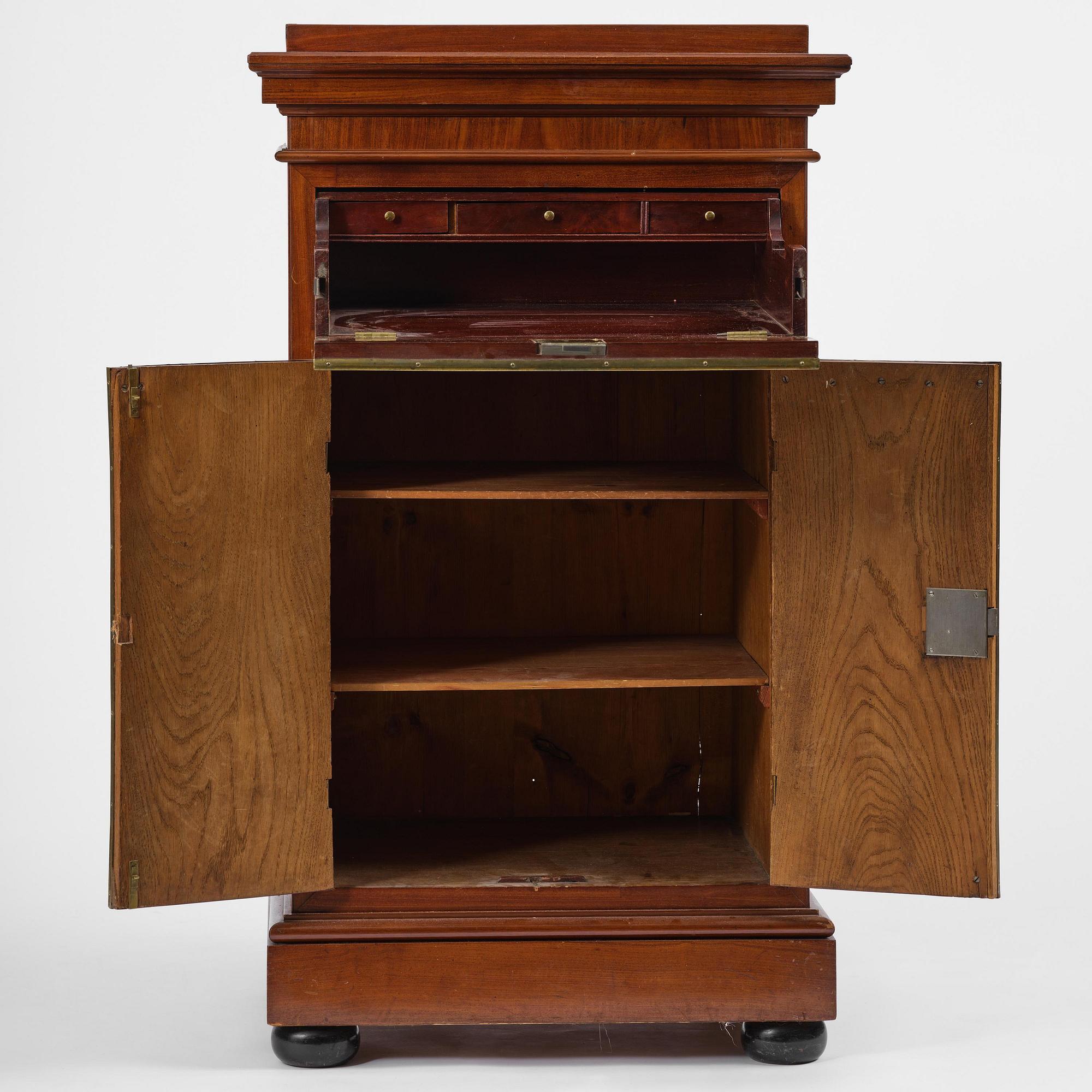 A late Gustavian mahogany column-cabinet, Stockholm, circa 1800.