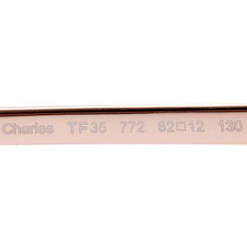 TOM FORD, a pair of gold colored sunglasses.