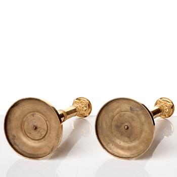 A set of four Empire presumably Russian candlesticks in gilded bronze.
