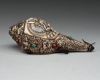 A elaborately decorated ritual Tibetan Conch-shell horn.