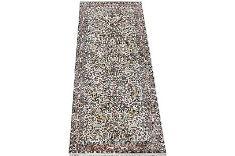 A carpet, silk Kashmir, c. 300 x 92 cm.