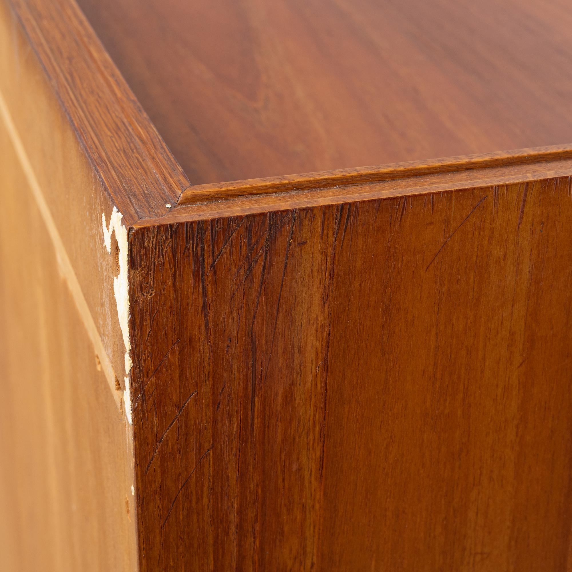 A teak-veneered mid 20th century sideboard.