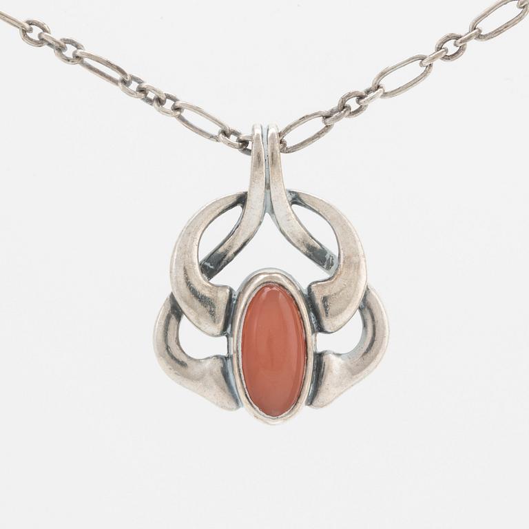 A silver and moonstone jewellery set consisting of necklace and earrings by Georg Jensen, jewellery of the year 2006.