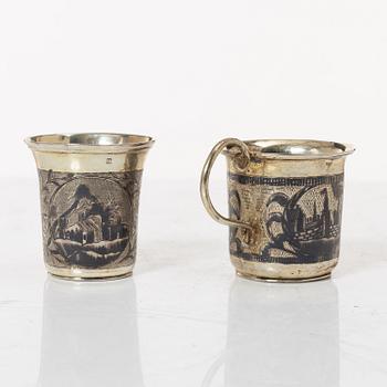Two Russian parcel-gilt silver niello vodka cups, Moscow 1832 and 1845.