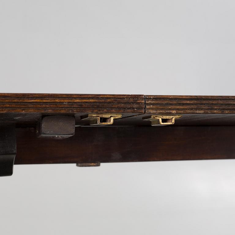 An english style dining table and eight chairs, second half of the 20th century.