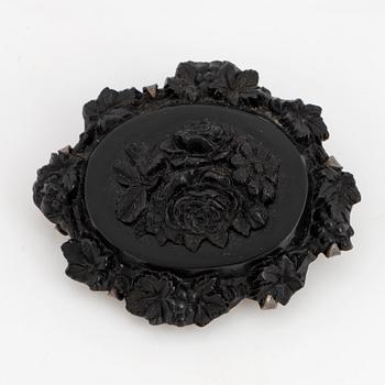Carved possibly jet/coal and silver brooch.