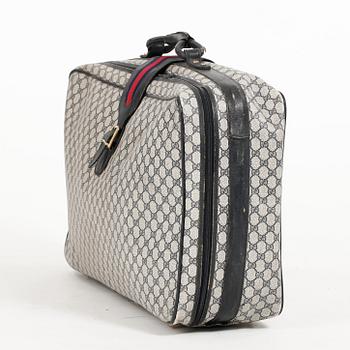 GUCCI, a blue monogram canvas suitcase.